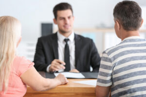 Man and woman meet with family lawyer in Canton